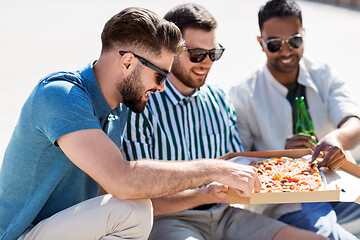 Image showing male friends eating pizza with beer on street