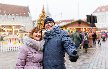 Image showing senior couple taking selfie at christmas market