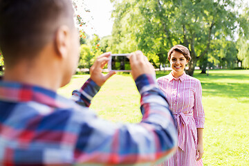 Image showing couple photographing by smartphone in park