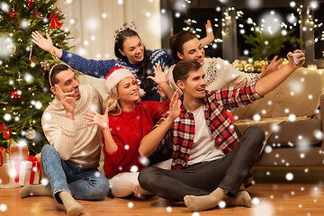 Image showing friends celebrating christmas and taking selfie