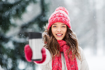 Image showing young woman with hot drink in tumbler in winter