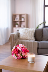 Image showing burning fragrance candle and flower bunch at home