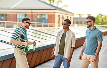 Image showing happy male friends drinking beer at rooftop party