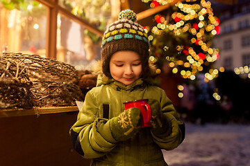 Image showing happy boy with cup of tea at christmas market
