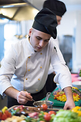 Image showing Chef finishing steak meat plate