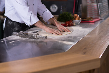 Image showing chef preparing dough for pizza