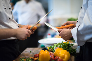 Image showing chefs hands cutting carrots