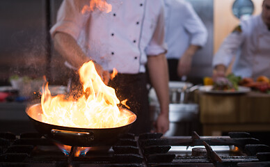 Image showing Chef doing flambe on food