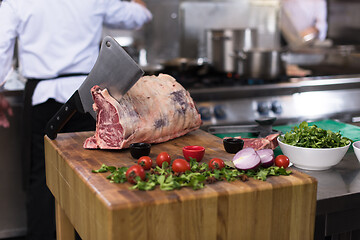 Image showing chef cutting big piece of beef