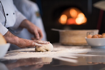 Image showing chef hands preparing dough for pizza