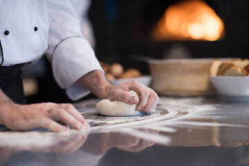 Image showing chef hands preparing dough for pizza