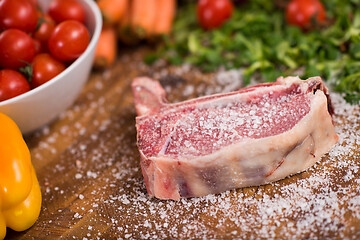 Image showing Juicy slice of raw steak on wooden table