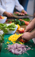 Image showing Chef hands cutting fresh and delicious vegetables