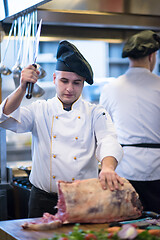 Image showing chef cutting big piece of beef