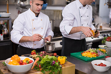 Image showing team cooks and chefs preparing meals