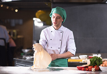 Image showing chef throwing up pizza dough