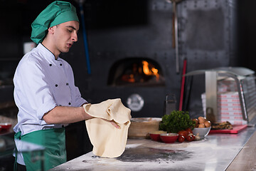 Image showing chef preparing dough for pizza