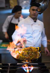 Image showing Chef doing flambe on food