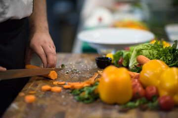 Image showing chef hands cutting carrots