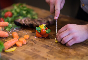 Image showing closeup of Chef hands preparing beef steak