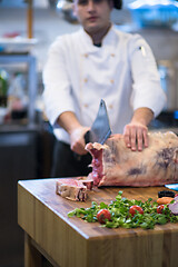 Image showing chef cutting big piece of beef