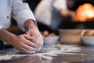 Image showing chef hands preparing dough for pizza