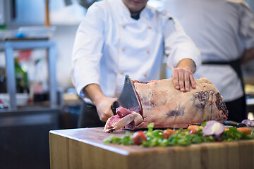 Image showing chef cutting big piece of beef