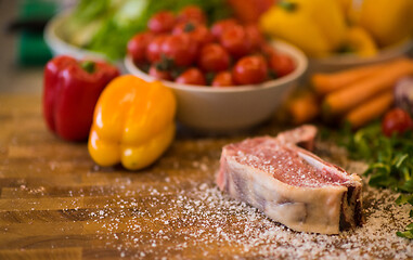 Image showing Juicy slice of raw steak on wooden table