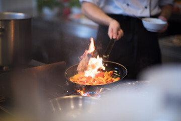 Image showing Chef doing flambe on food