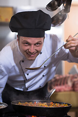 Image showing chef tasting food with spoon