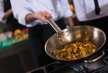 Image showing chef flipping vegetables in wok