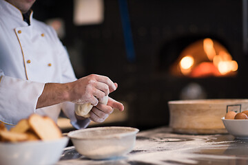 Image showing chef hands preparing dough for pizza