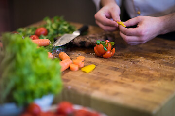 Image showing closeup of Chef hands preparing beef steak