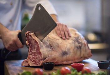 Image showing chef cutting big piece of beef