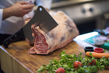 Image showing chef cutting big piece of beef