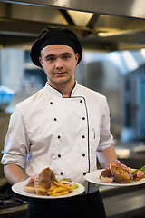 Image showing Chef showing dishes of tasty meals