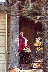 Image showing Girl standing on old house balcony