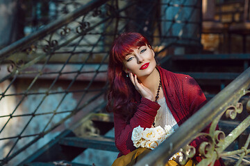 Image showing Girl sitting on old house stairs