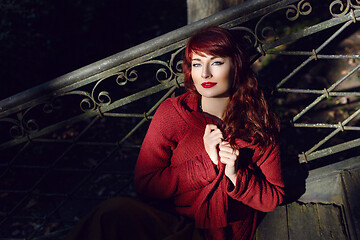 Image showing Girl sitting on old house stairs