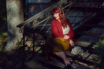 Image showing Girl sitting on old house stairs