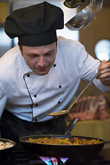 Image showing chef tasting food with spoon