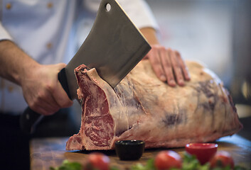 Image showing chef cutting big piece of beef