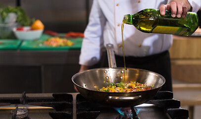 Image showing chef flipping vegetables in wok