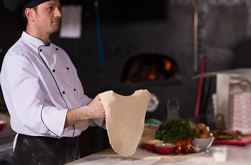 Image showing chef throwing up pizza dough