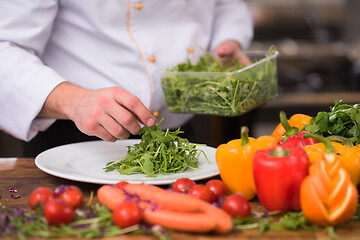 Image showing chef serving vegetable salad