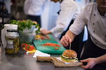 Image showing chef finishing burger