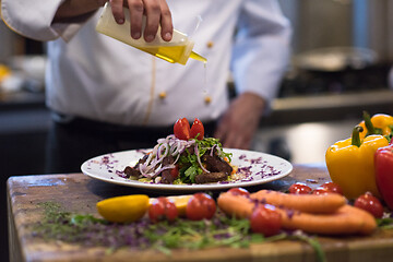 Image showing Chef finishing steak meat plate