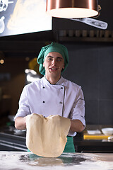 Image showing chef throwing up pizza dough