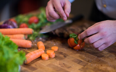 Image showing closeup of Chef hands preparing beef steak