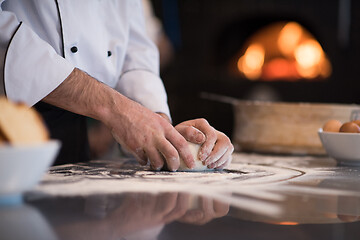 Image showing chef hands preparing dough for pizza